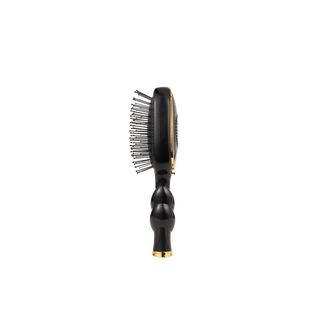 Black hairbrush with gold accents on a white background