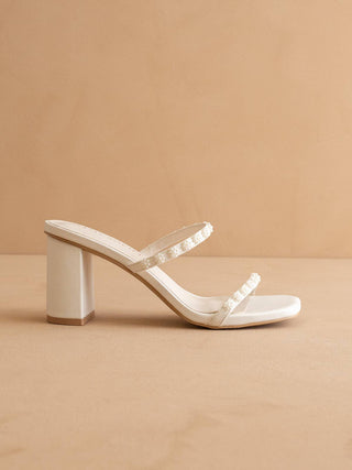 Beige sandal with a block heel on a beige background