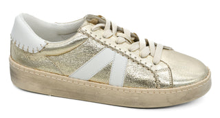 Gold and white sneaker on a white background