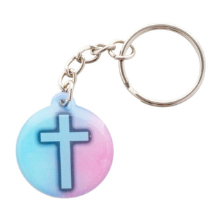 Keychain with a cross design on a gradient blue and pink background