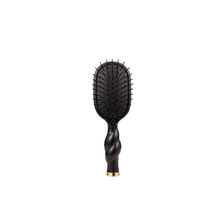 Black hairbrush with gold accent on a white background