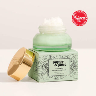 Green lip scrub jar with gold lid on a white background, featuring 'Poppy & Pout' branding and an 'Allure' award badge.