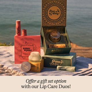 Lip care products with packaging on a textured surface near water