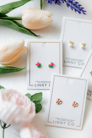 Earrings on LINNY CO cards with tulips and lavender in the background