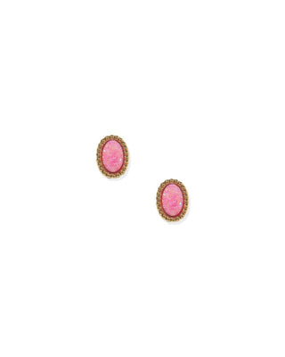 A pair of oval stud earrings featuring textured pink cabochon stones set in a gold-toned, beaded halo border, shown on a plain white background.