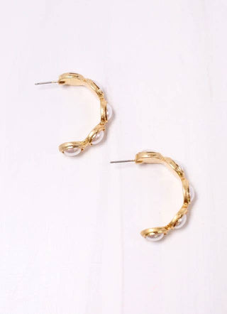 Gold hoop earrings on a white background