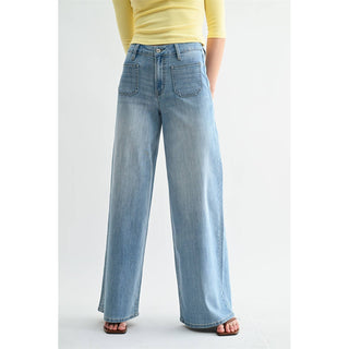 Person wearing light blue wide-leg jeans on a white background