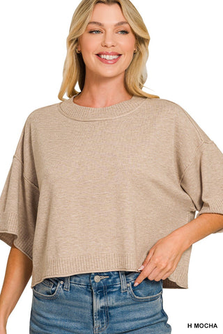 model wearing mocha colored short sleeve sweater with a white background
