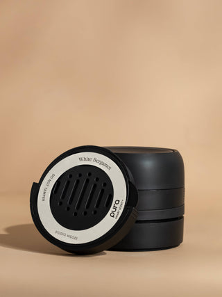 Black and white container with 'White Bergamot' branding on a beige background