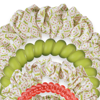 Set of green, red, and white scrunchies with floral pattern on a white background