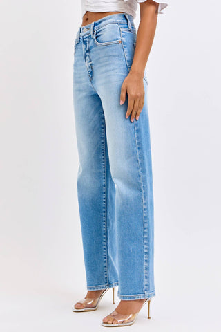 Light blue jeans worn by a person on a white background