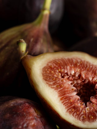 Close-up of a sliced fig with a dark background