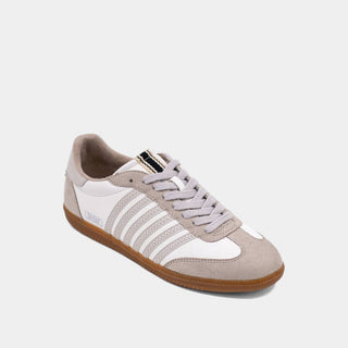 Sneaker with white and brown color scheme on a light gray background
