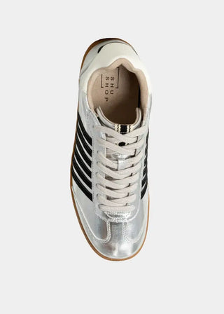 Silver sneaker with black stripes on a white background