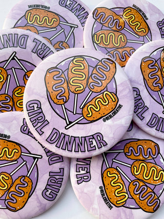 Buttons with 'Girl Dinner' design featuring hot dogs on a white background