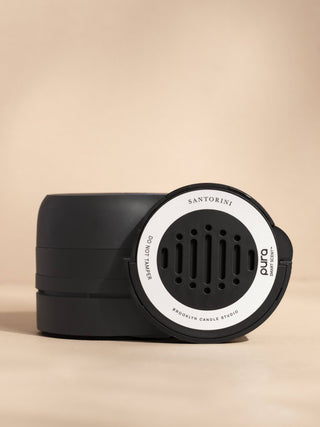 Black and white diffuser with 'Santorini' branding on a beige background