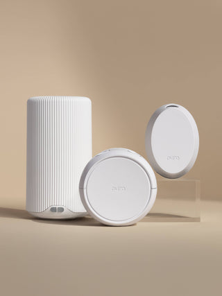 Three white electronic devices on a beige background