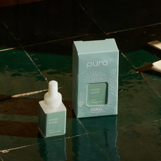 Pura skincare product bottle and box on a reflective surface