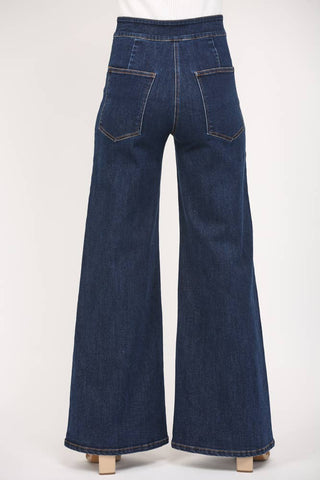 Blue denim bell-bottom pants on a white background