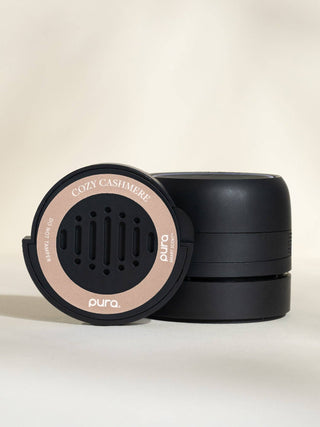 Black and beige cylindrical product with 'pura' branding on a beige background