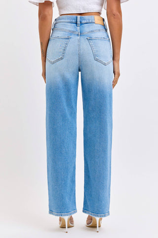 Light blue jeans worn by a person on a white background