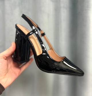 Sweet Magnolia Heels in black patent leather, held in hand