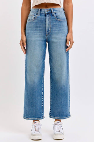 Person wearing blue jeans on a white background