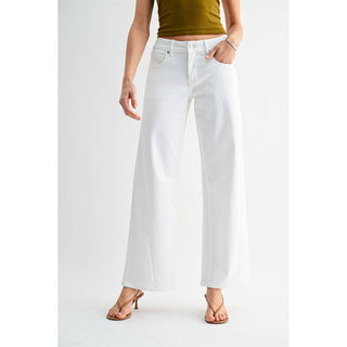 Person wearing white wide-leg jeans on a plain background