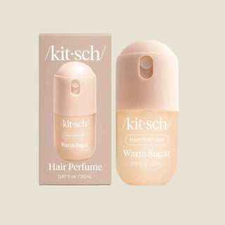 Kit Sch Warm Sugar hair perfume shown with its retail box and the perfume bottle itself on a light gray background.