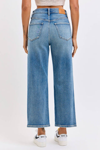 Person wearing blue jeans with a white background