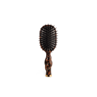 A paddle hairbrush with a glossy tortoiseshell handle and black bristles, centered on a plain white background.