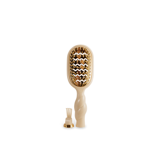 Beige paddle hair brush with gold bristle head on a white background