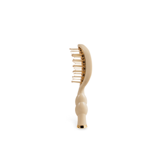 Beige hairbrush on a white background
