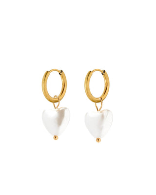 Gold hoop earrings with white heart-shaped charms on a white background