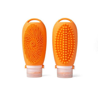 Two orange silicone scrubbers with textured surfaces on a white background