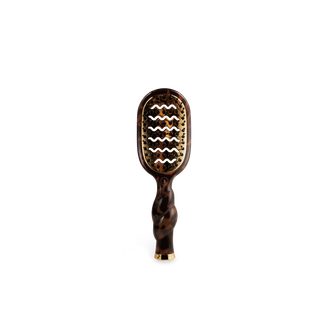 Wooden hairbrush with wavy pattern on a white background