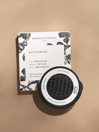 Brooklyn Candle Studio Santorini car diffuser and its matching floral-patterned box on a beige background.