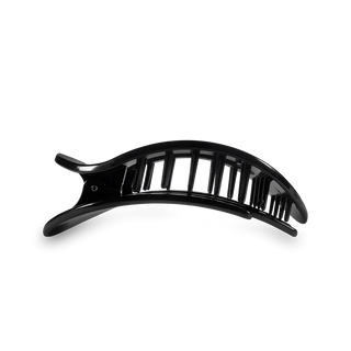 Black flat hair clip with teleties logo on a white background
