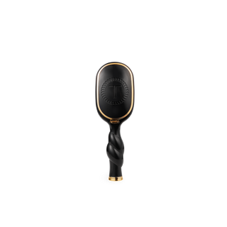 Black hairbrush with gold accents on a white background