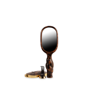 Tortoiseshell hand mirror with a black center on a white background