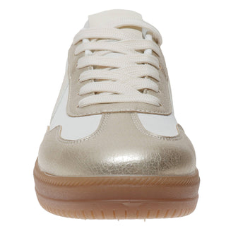 White and gold sneaker with a brown sole on a white background