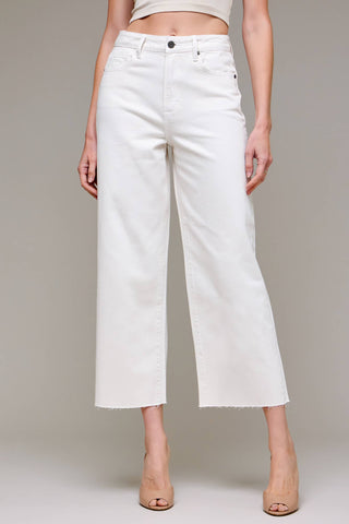 White wide-leg jeans worn by a person on a plain background