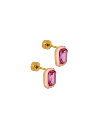 Gold earrings with pink gemstones on a white background