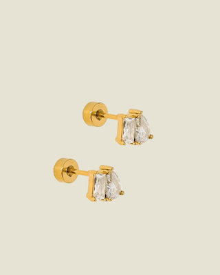 Gold earrings with clear gemstones on a white background