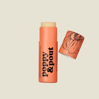 Lip balm stick with 'Poppy & Pout' branding on a pink background