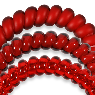 Close-up of red glass beads on a white background