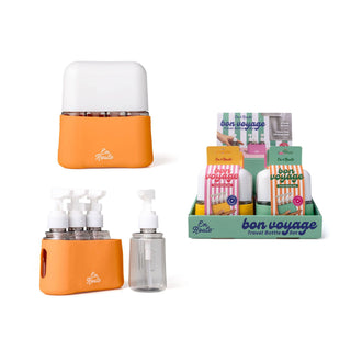 Orange travel bottle set with 'bon voyage' packaging on a white background