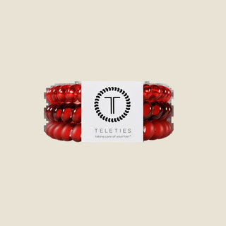 Red hair ties with a white label on a white background