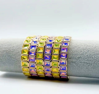 Ring with multicolored gemstones on a white background
