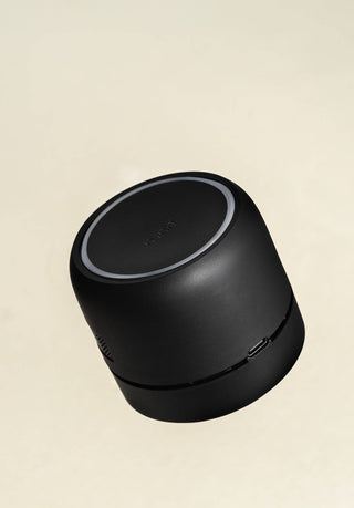Black cylindrical device with 'pura car defuser branding on a beige background